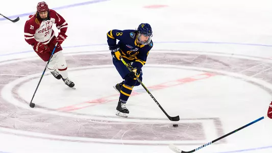 Lexie Adzija skates past a Colgate player