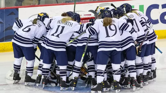 Women's hockey huddles before puck drop