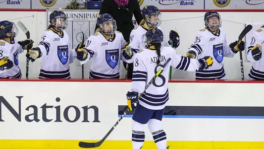 Lexie Adzija skates through the hand shake line after scoring