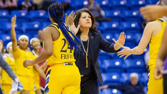 Tricia Fabbri welcomes her team to the bench
