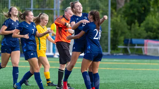 Women's soccer celebrate after scoring