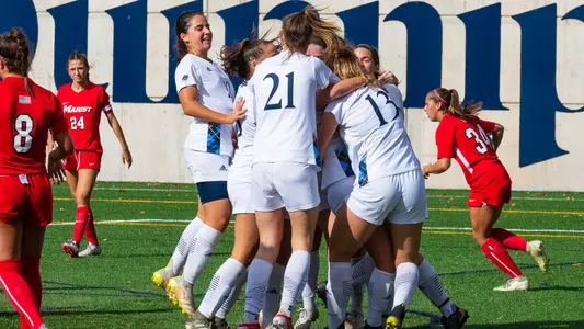 Women's soccer celebrates after goal