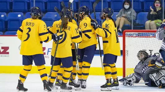 Women's Hockey celebrates goal vs Saint Anselm