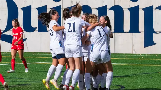 Women's soccer celebrates after a goal