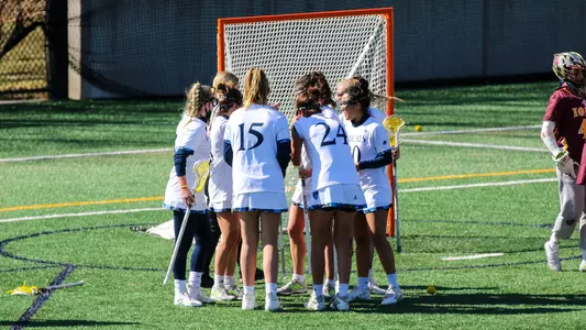 Women's Lacrosse Huddles After Scoring a Goal Against Iona