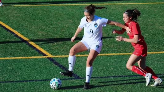 Kayla Mingachos holds off a Marist defender
