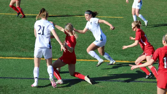 Rebecca Cooke and Markela Bejleri try to take the ball from Marist
