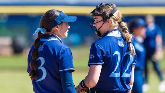 Kat Rodriguez and Julia Woeste talk at the plate