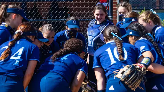 Softball huddles before taking the field