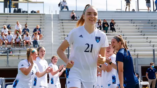 Rebecca Cooke runs through high-five line during starting lineup announcements