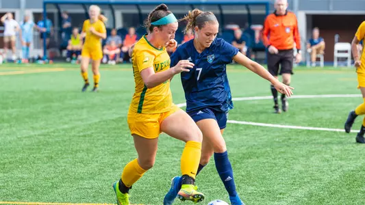 Taylor Dowdell battles with Vermont player for the ball