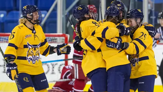 Women's hockey celebrates after goal