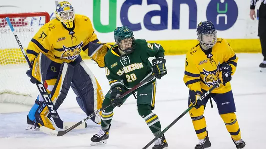 Kate Reilly defends, Logan Angers watches in net