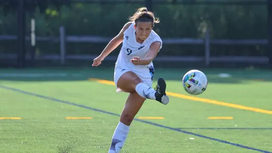 Kayla Mingachos kicks the ball deep down the field against Stoney Brook