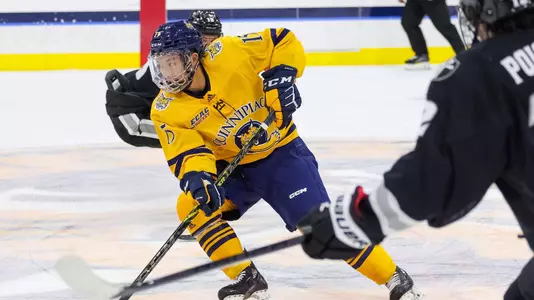 Jayden Lee skates up ice against Providence