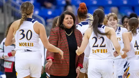 Tricia Fabbri welcomes her team to the bench
