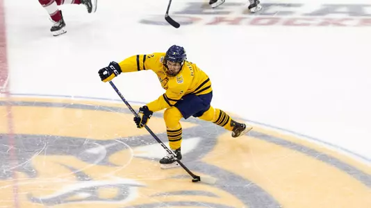 Jake Johnson takes the puck up ice against Colgate