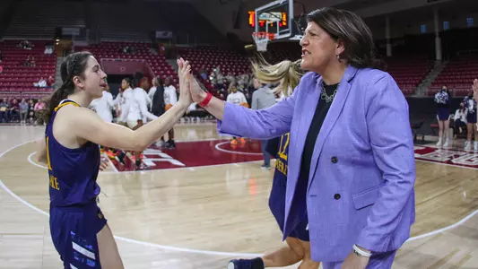 Jackie Grisdale and head coach Tricia Fabbri dap it up pregame