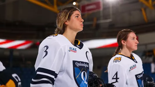 Zoe Boyd stands on the blue line for the national anthem against UCONN