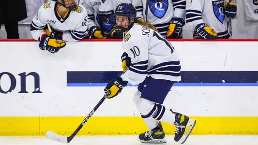 Jess Schryver skates with the puck against UCONN