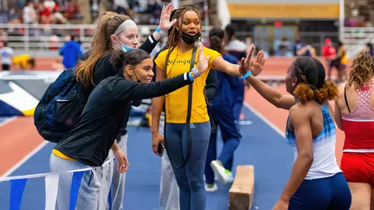 Aisha Gay celebrates with teammates after event