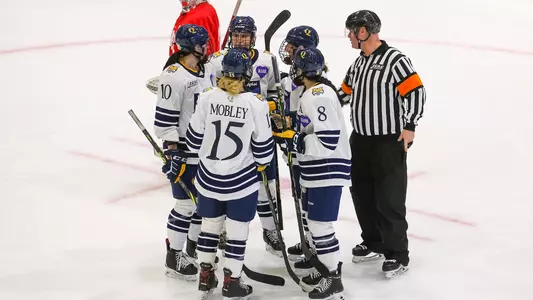 Team huddles before face off vs Cornell