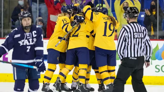 Women's ice hockey celebrates after scoring a goal vs Yale