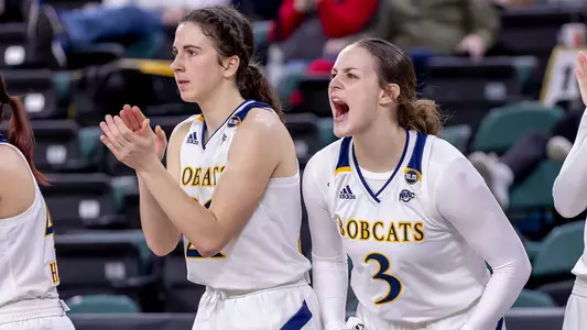 Halee Smith and Jackie Grisdale celebrate from the bench