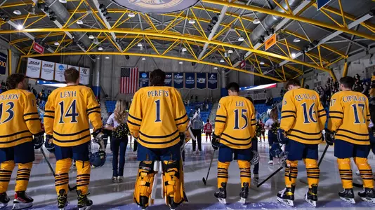 Men's Hockey Stands for National Anthem