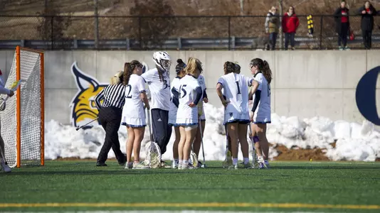 Women's Lacrosse Huddles After Goal Against Boston University