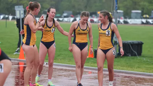 Group of Bobcats huddle after 3000m steeplechase