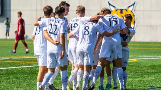 QU MSOC huddles on the pitch
