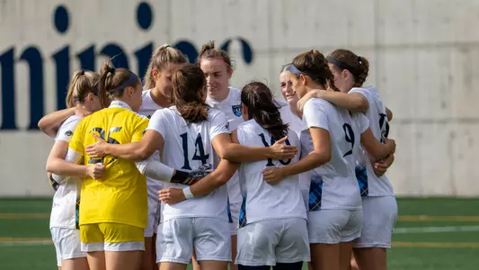 QU WSOC huddles on the pitch