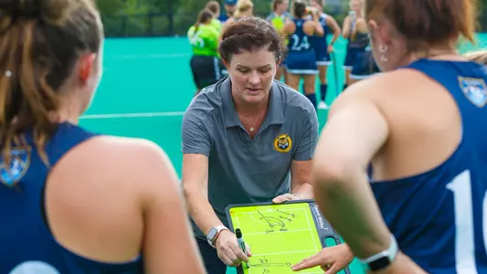 QU Field hockey HC Becca Main draws up a play