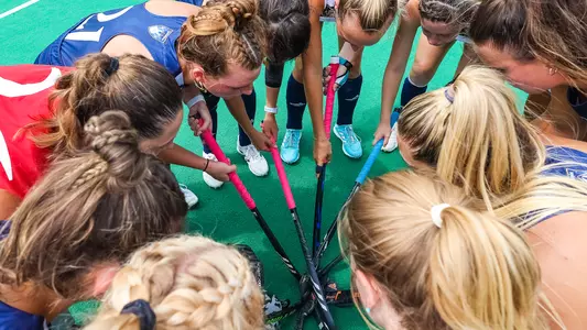Field hockey team gathers in a pregame huddle