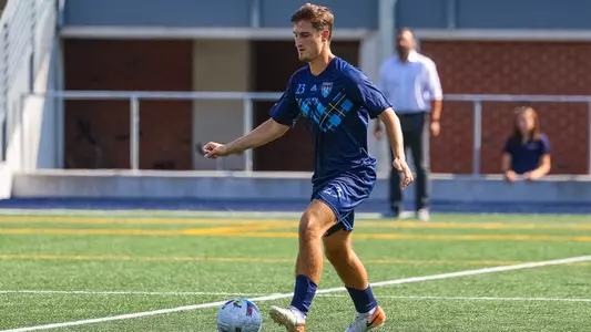 Domen Bozic dribbles the ball upfield