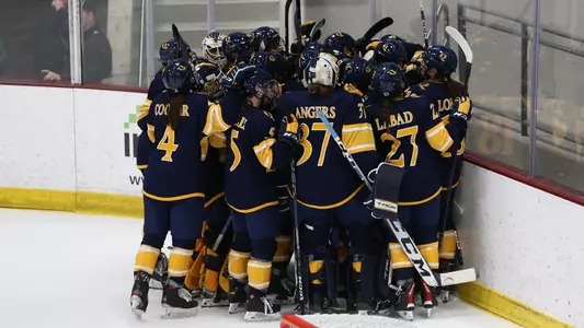 Women's ice hockey team celebrates a win over No. 5 Colgate
