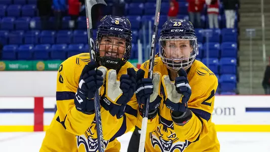 Captain Lexie Adzija and Nina Steigauf celebrate after a win against Wisconsin