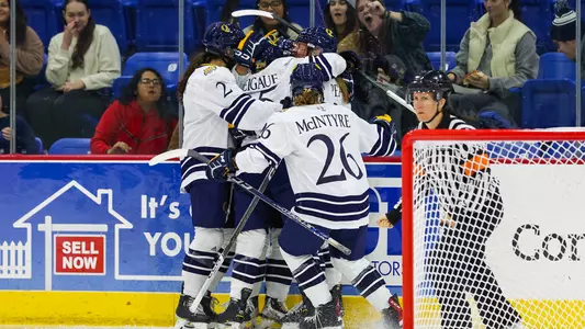 The QU WIH Team celebrates a goal versus Maine