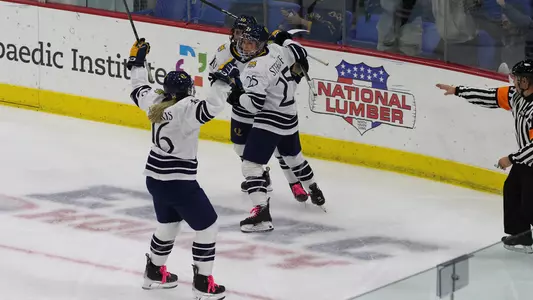Quinnipiac women's ice hockey team celebrates a goal versus Brown