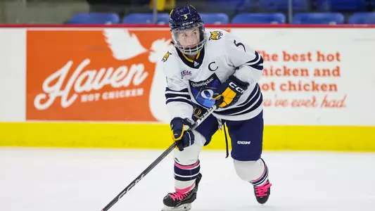 Kate Reilly looks to pass the puck in a game against Yale (10.21)