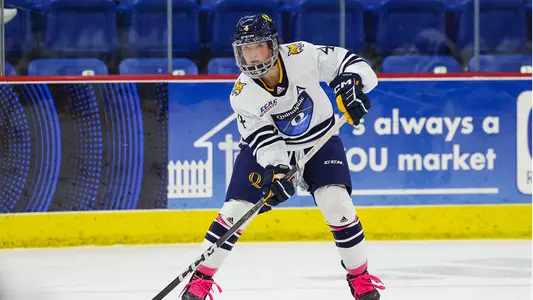 Kendall Cooper shoots a puck in a game versus Yale