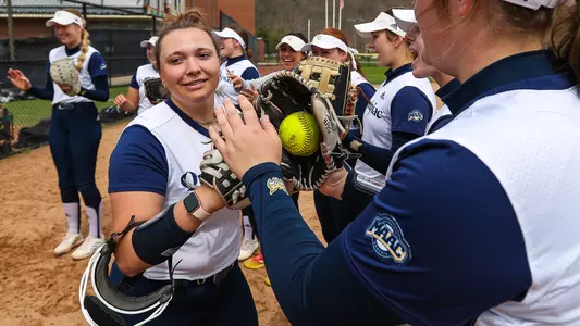 Sydney Horan runs through the line of Bobcats giving high fives during starting lineups