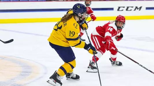 Courtney Vorster clears the puck out of the Bobcats defensive zone through a Wisconsin forward