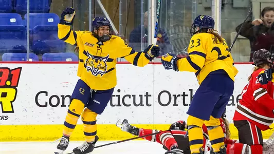 Alexa Hoskin and Sadie Peart celebrate Hoskin's goal against St. Lawrence in the first round of the ECAC Hockey Playoffs