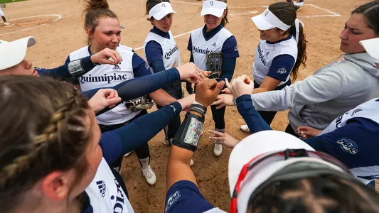 Quinnipiac softball huddles up before a matchup against Rider