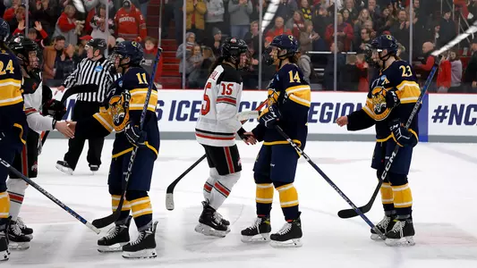 Quinnipiac women's ice hockey shakes hands with Ohio State at center ice in the NCAA Regional Tournament Final