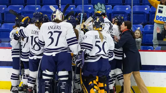 The women's ice hockey team celebrates their overtime victory against St. Lawrence to advance to the ECAC semifinals