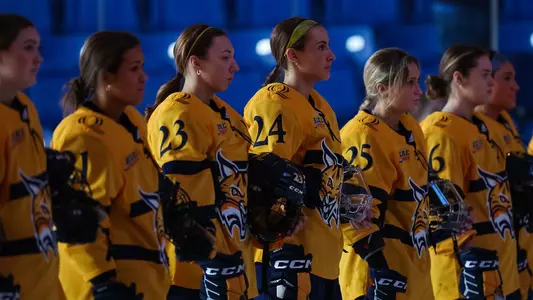 Quinnipiac women's ice hockey stands on the blue line for the national anthem against St. Lawrence in the quarterfinals