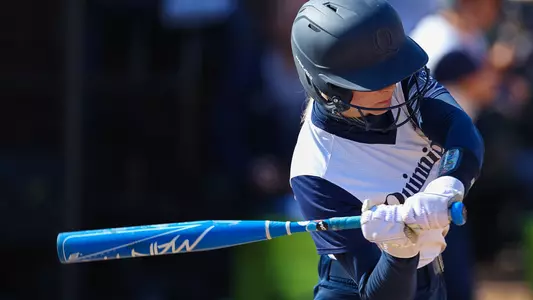 A Quinnipiac softball member takes a swing during an at bat against Holy Cross